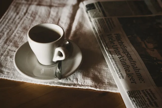 image_suggestion: finance newspaper and coffee on a work desk