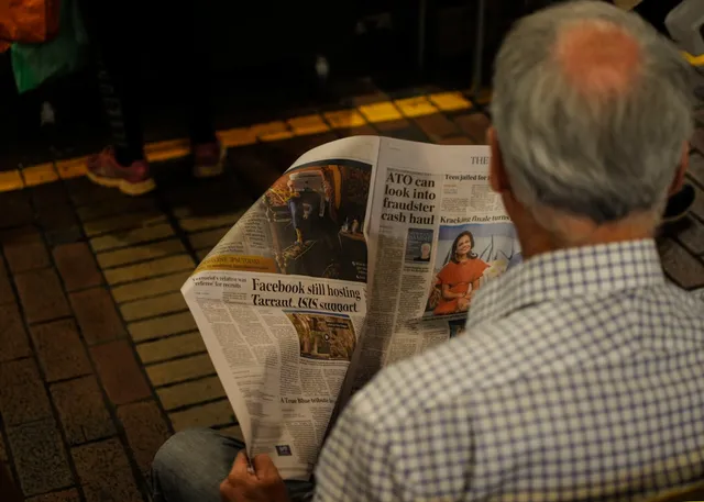 image_suggestion: person reading a financial newspaper