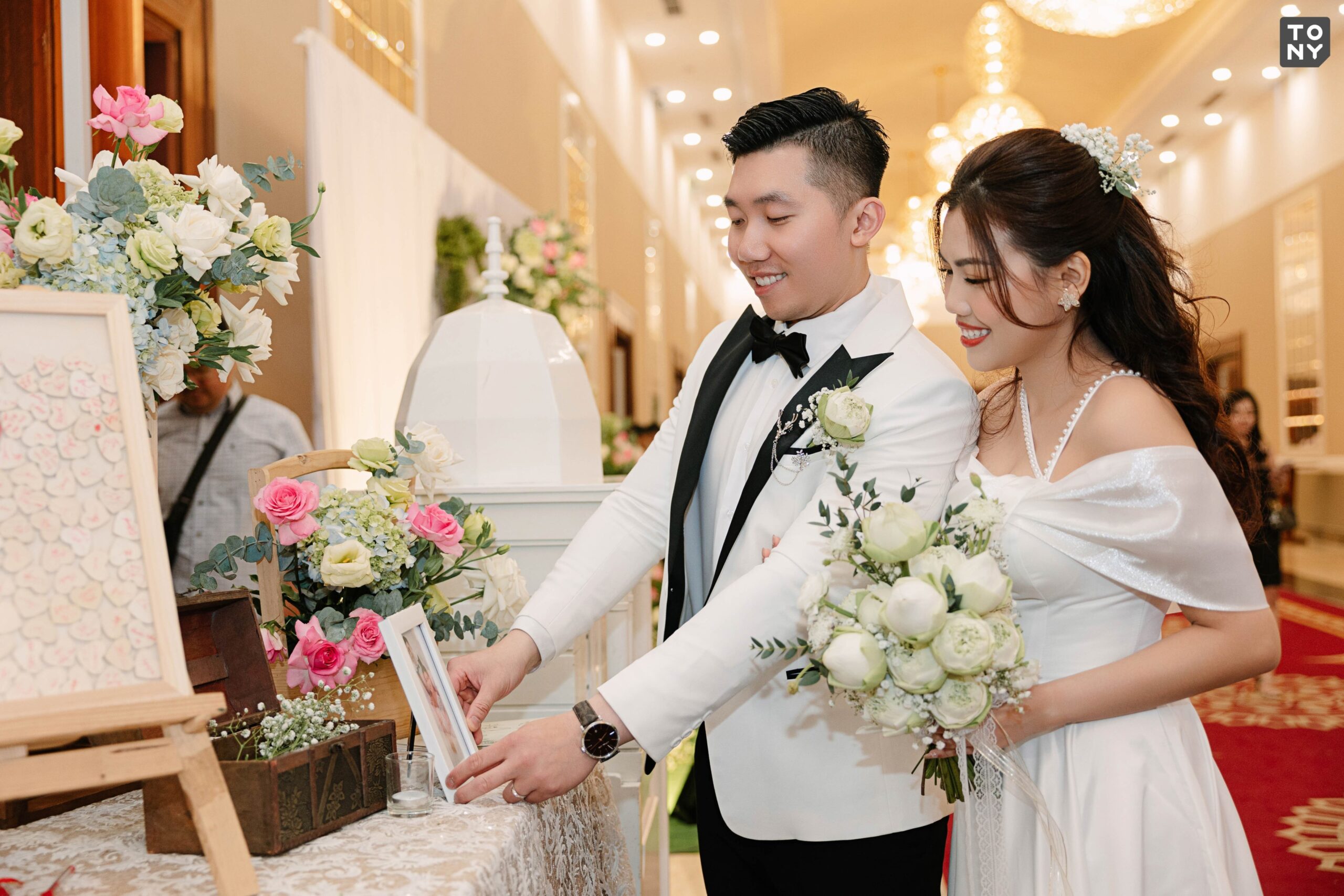 Sắp xếp khung ảnh cưới kết hợp cùng hoa tươi trải dài