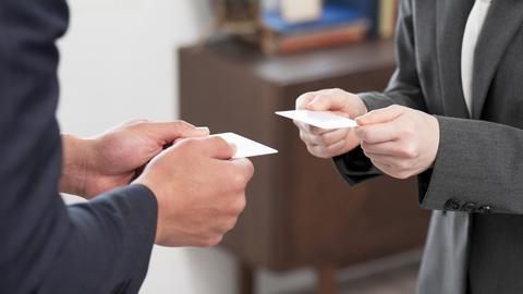 professionals exchanging business cards
