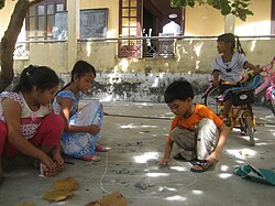 Trẻ em và người lớn cùng tương tác qua ván chơi ô ăn quan thực tế