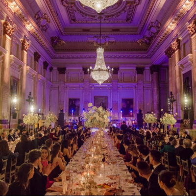 Stressed couple surrounded by wedding planning paperwork and sticky notes