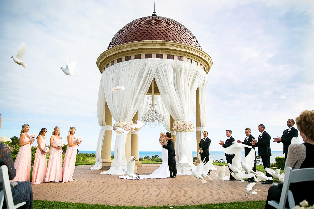 Wedding planner consulting couple at planning meeting with mood board and budget sheet