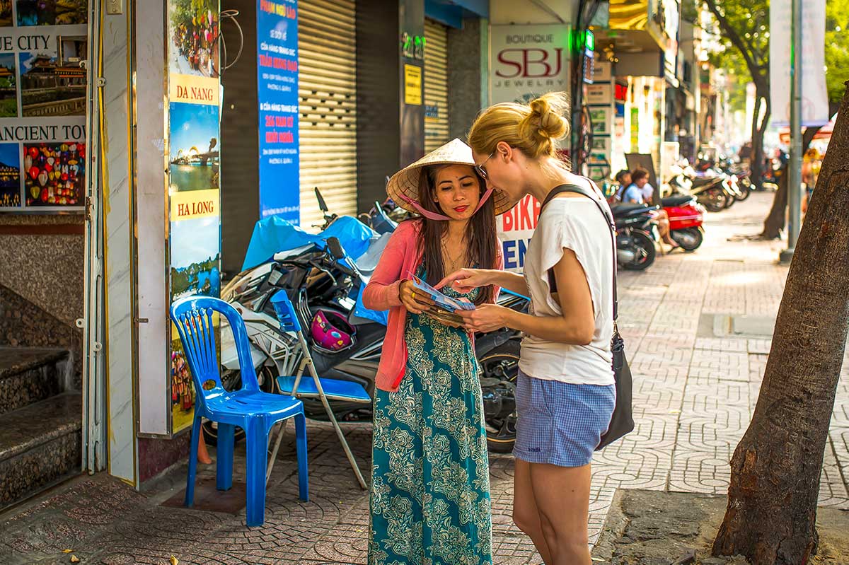 Female solo traveler with backpack exploring Vietnamese market
