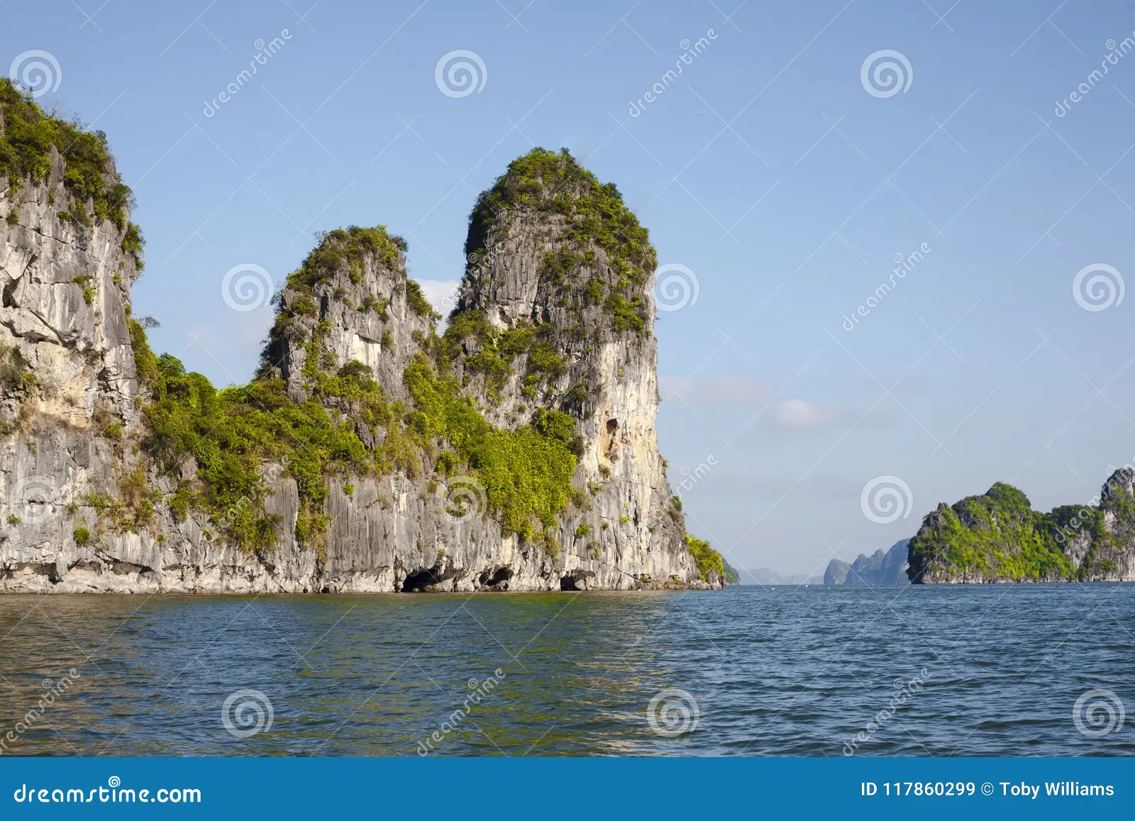 Ha Long Bay limestone karsts at sunrise viewed from a traditional junk boat deck
