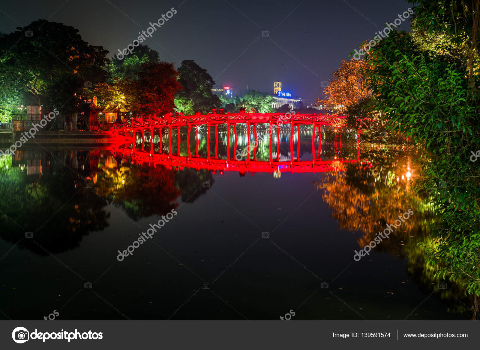 Hoan Kiem Lake at dawn with Turtle Tower reflected in still water, Hanoi old quarter