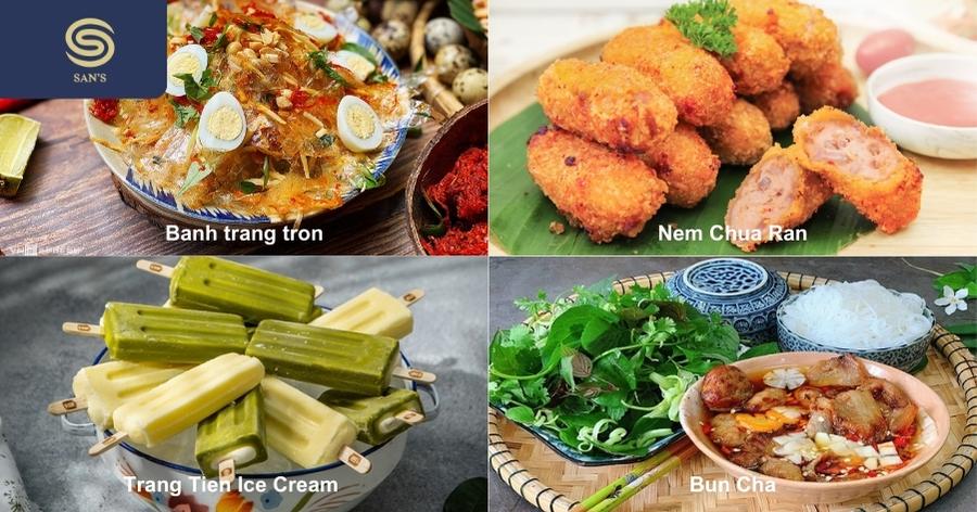 A steaming bowl of Hanoi-style pho bo with fresh herbs and lime on a street food stall