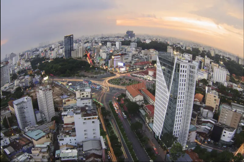 Ben Thanh Market exterior at dusk with street food vendors and motorbike traffic in Saigon