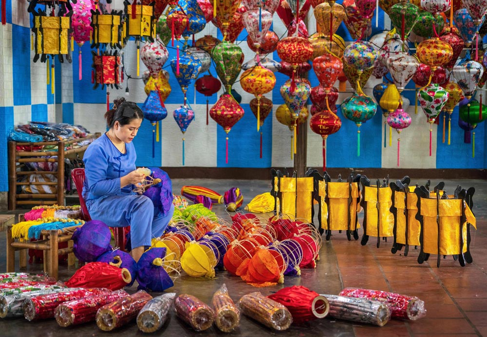 Boutique hotel courtyard in Hoi An ancient town with traditional Vietnamese lanterns and architecture