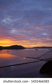 Luxury infinity pool overlooking the ocean at a Phu Quoc resort at golden hour