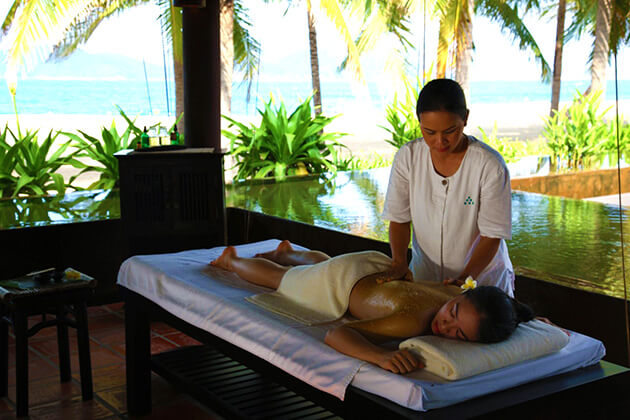 Wellness spa treatment room with natural lighting and herbal ingredients Vietnam resort